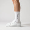 Tourismo Crew Socks white, worn, side view with white sneakers