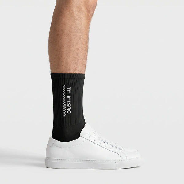 Tourismo Crew Socks black, worn, side view with white sneakers
