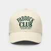 Vue de face d’une casquette beige Paddock Club Tourismo avec broderie verte