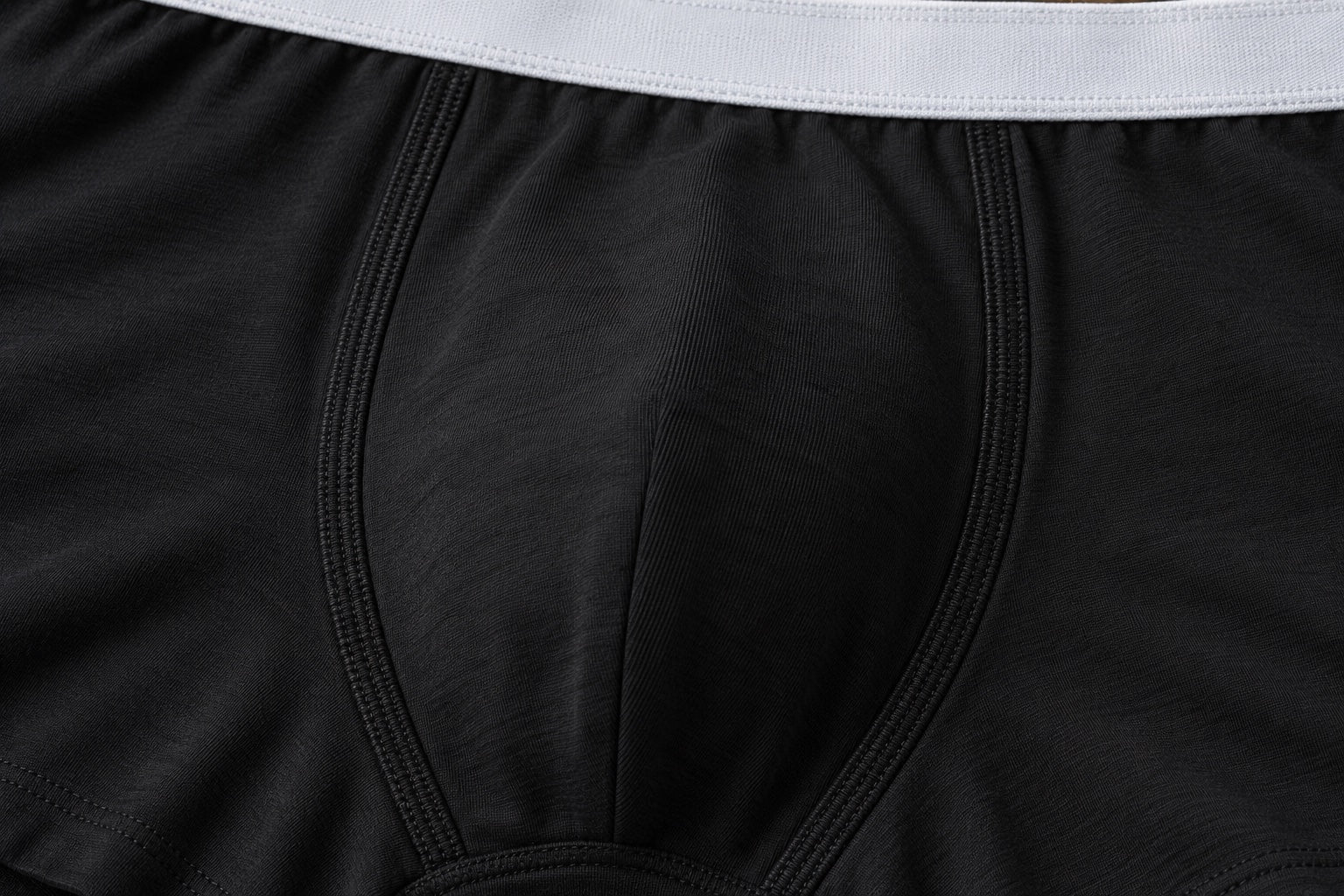 Illustrative macro detail of black fabric and front-panel stitching